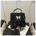 Fashionable black pleated backpack with silver butterfly detail and flap closure - Black