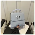 Light blue faux leather butterfly backpack with marble texture and silver metal clasp - Blue