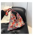 Floral canvas shoulder tote bag with knotted strap and colorful flower pattern print - Red