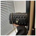 Classic black quilted crossbody bag with gold chain strap and turn-lock closure - Black