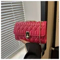 Rose pink quilted chain crossbody bag with gold metallic lock and faux leather texture - Red