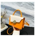 Minimalist orange and off-white crossbody handbag with metallic buckle and leather handle - Orange