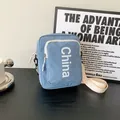 Light blue nylon crossbody bag with China letter print and cream white strap - Light Blue