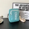 Teal messenger bag with white China lettering and adjustable strap for college students - Green