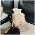 Beaded handle straw crossbody bag with beige woven body and gold chain strap - White