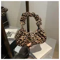Detail of trendy leopard print handbag featuring a vintage-style ruched circular handle - Dark Brown