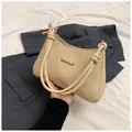 Beige woven hobo bag with thick knotted rope handle and elegant gold metal buckle details - Khaki