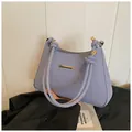 Blue and white striped canvas shoulder bag with braided rope handle and gold accents - Blue