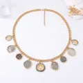 Luxurious gold chain necklace with geometric coin pendants and textured metallic charms - Gold Necklace