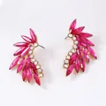 Detailed close-up of gold-plated feather stud earrings with pink marquise zircon stones - Rose Red