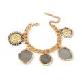 Detailed close-up of a vintage gold alloy bracelet with five textured coin charms - Bracelet