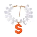 Detail of beaded necklace with orange leather S pendant and golden metal accents - Letter S