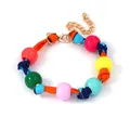Close-up of colorful round beads with striped woven rope and gold lobster clasp - Striped Fabric Vibrant Bead Style (Fig 4)