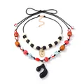 Double layered geometric beaded necklace with black music note pendant and sun charm - Bohemian Multicolor Layered Style