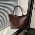 Large capacity dark brown soft leather tote bag with punk style 3D skeleton rib design - Brown