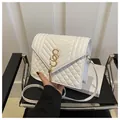 Detail of white quilted crossbody bag with gold chain logo and elegant fringe tassel - White