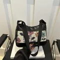 Vintage floral printed shoulder bag with black leather stitching and wide adjustable strap - Black