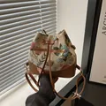 Borsa a secchiello retrò in jacquard floreale con finiture marroni e coulisse - Marrone