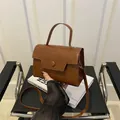 Brown structured faux leather crossbody bag with unique geometric flap and top handle - Dark Brown