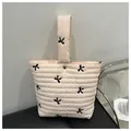 Quilted light pink makeup bag with black bow embroidery and silver metal snap button - Pink