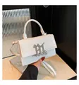 Chic white crocodile embossed square handbag with gothic silver logo and top handle - White