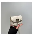 Quilted cream white mini crossbody bag featuring a golden heart buckle and chain strap - White