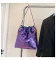 Sparkly purple sequin drawstring bucket bag with gold chain strap on display - Purple