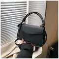 Chic black embossed leather square bag with clover pattern and gold hardware details - Black