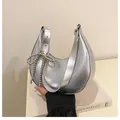 Silver crescent underarm bag with crushed texture and bead bow charm accessory - Silver