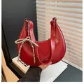 Red crescent moon underarm bag with cracked patent leather and silver bow charm - Red