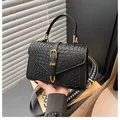 Women's black woven crossbody bag with gold buckle and patterned shoulder strap - Dark Brown