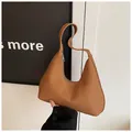 Detailed close-up of woven diamond texture on luxury camel hobo crescent shoulder bag - Dark Brown