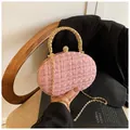 Pink tweed evening bag with gold chain strap and metallic handle on a stylish background - Pink
