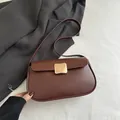 Minimalist dark brown leather crossbody bag featuring a square gold buckle and soft matte finish - Brown
