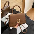 Brown leather crossbody handbag with golden oval buckle and adjustable strap - Dark Brown