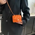 Mini orange crossbody bag with quilted rhombus pattern and golden flower lock - Orange
