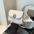Chic cream white saddle bag with golden U-shaped buckle in a mirrored display - Off White