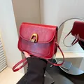 Vintage red faux leather saddle bag with gold metal buckle and thin shoulder strap - Red