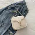 Creamy white saddle bag made of smooth faux leather with a golden metal twist lock closure - White