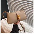Minimalist beige underarm bag with gold metal buckle and knotted strap detail - Khaki