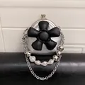 Mini silver kiss-lock crossbody bag featuring a 3D black flower and pearl chain - Silver