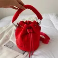Vibrant red plush bucket bag with THE BUCKET embossing and thick top handle strap - Red