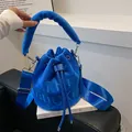 Electric blue velvet bucket bag with 'THE BUCKET' embossing and plush top handle - Blue