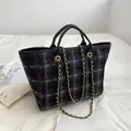 Minimalist large grey tweed bucket bag with black leather straps and gold chain detail - Black