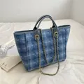 Blue denim tote bag with white diamond pattern, leather handles and gold chain strap - Blue