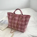 Pink checkered tweed bucket bag with leather handles and gold chain shoulder strap - Pink