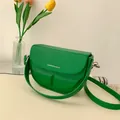 Schicke grüne Satteltasche in Halbkreisform mit breitem Gurt und modernem Design - Grün