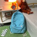 Minimalist light blue school backpack with side pockets and cute bear brand patch - Blue