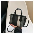 Stylish black and white striped canvas handbag with black leather trim and strap - Black