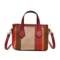 Vertical stripe knit bucket bag in warm orange and red tones with leather handle - Red